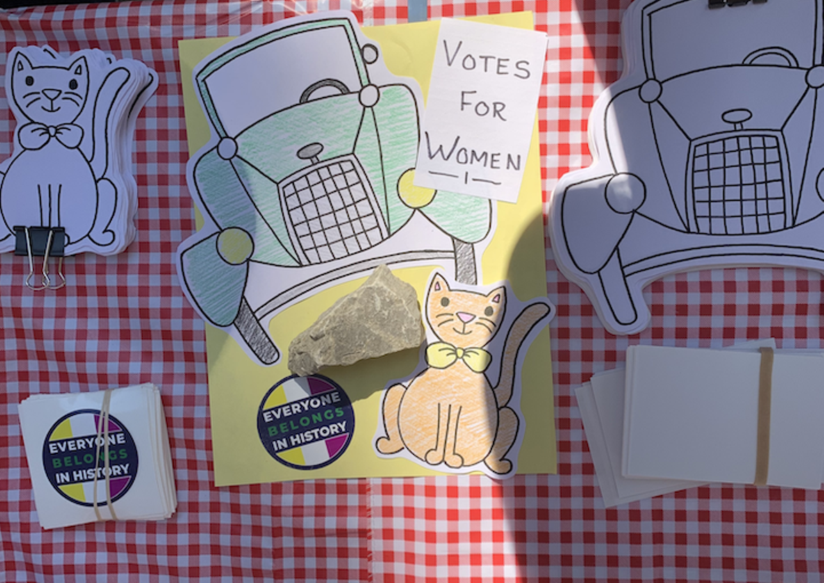Craft project featuring a car, cat, and women's suffrage sign