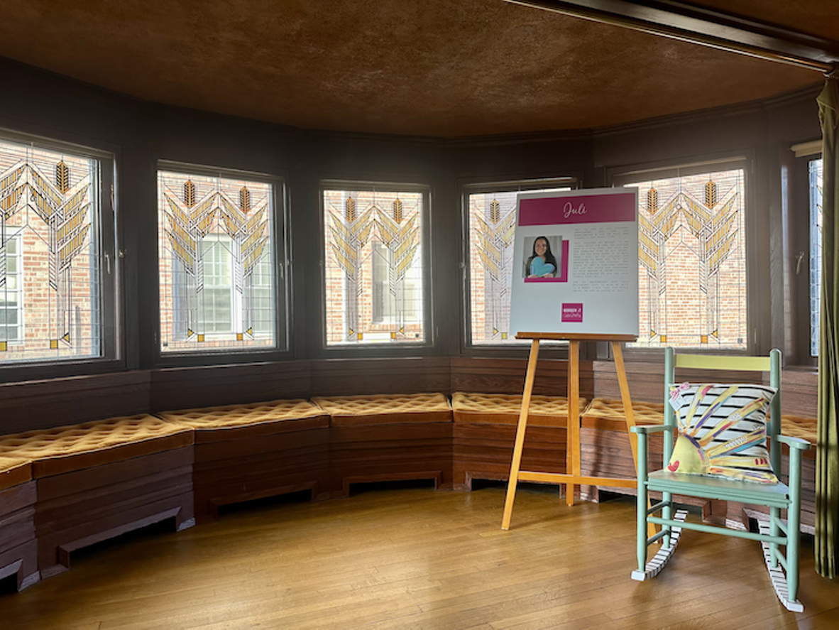 Hand painted chair and poster featuring artist in Dana-Thomas House breakfast nook.